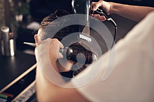 Youre a blow-dry away from a good mood. a woman blowdrying her clients hair in her salon.