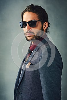 When youre this cool...Studio portrait of a stylishly dressed handsome young man wearing sunglasses.