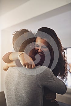 Youre everything my hearts ever wanted. an affectionate young couple hugging in the kitchen at home.