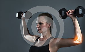 Youre only getting stronger. Studio shot of a sporty young woman building muscle in her arms.