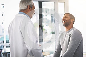 Youre in great shape. a senior doctor giving his male patient a thorough checkup during his consultation.