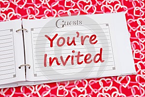 Youre Invited with retro old white and black guest book with hearts