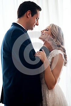 Youre the most angelic being I have ever seen. Cropped shot of a happy young couple standing indoors and holding each