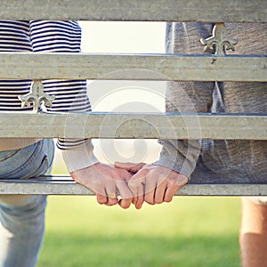 Youre my partner through life. Rearview shot of a young gay couple sitting together on a park bench.