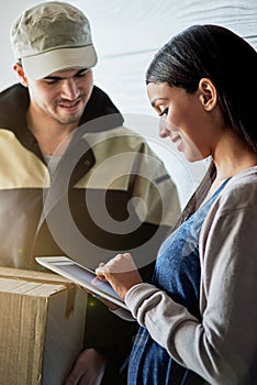 Youre welcome to leave feedback about your delivery as well. a young woman using a digital tablet to sign for her