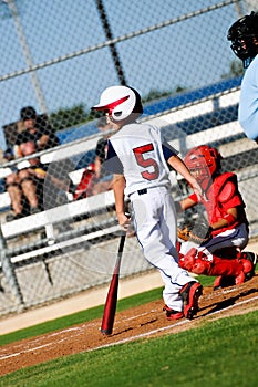 Youth baseball boy about to bat looking at pitcher.