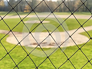 Youth baseball field viewed from behind net