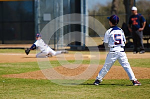 Youth pitcher after throw to first