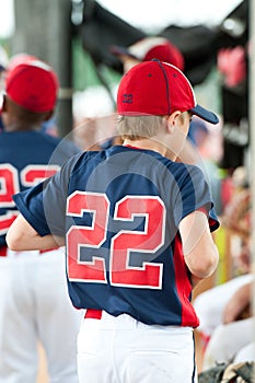 Youth baseball player in the dugout