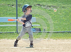 Youth Baseball Playter at Bat and in Mid-Swing