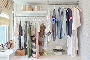 Youth cloths hanging in open wardrobe in bedroom photo