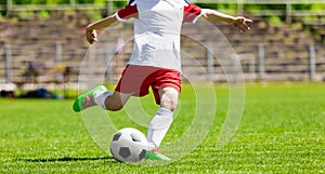 Youth Football Soccer Player Hits a Ball. Footballer Kicking Ball