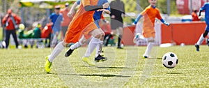 Youth football tournament game. Sporty boys kicking football game