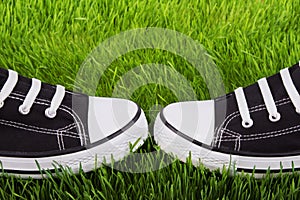 Youth gym shoes on a green grass