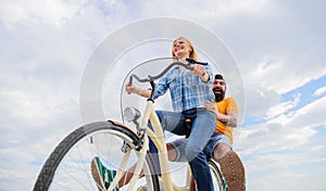Youth have fun riding bike sky background. Enjoy summer holidays vacation riding bike. Couple in love happy cheerful