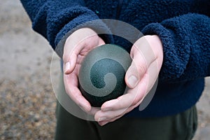 Youth holds an emu egg on a farm in Northumberland, UK. Keeping emus is increasingly