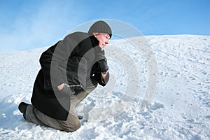 Youth leaning on one knee on snow