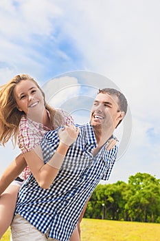 Youth Lifestyle, Summer Vacations, Dating, Love, Happiness Concepts. Happy caucasian Couple Piggybacking Outdoors. Against Nature