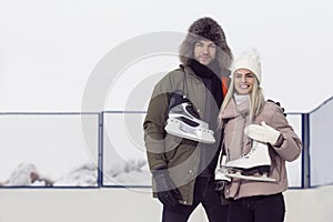 Youth Lifestyle. Young Loving  Caucasian Couple On Skatingrink With Ice Skates Posing Together Embraced