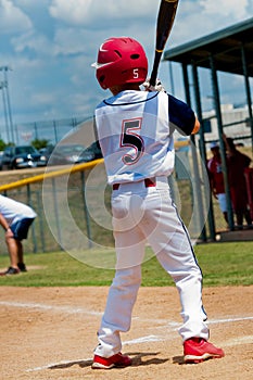 Youth little league baseball batter.