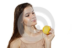 Youth secrets. Beautiful young woman with lemon over white background. Cosmetics and makeup, natural and eco treatment