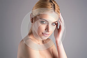 Youth and skin care concept. Photo of sensual model isolated on studio background. Close up portrait of beautiful woman