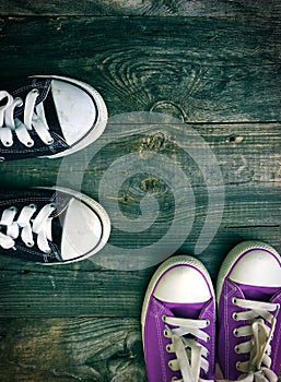 Youth sneakers on a gray wooden surface