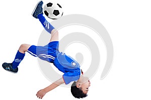 Youth soccer player kicking the ball