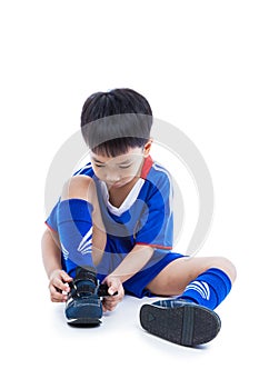 Youth soccer player tying shoe and prepare for competition. Sport lifestyle. Isolated on white