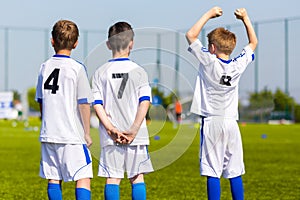 Youth sport team players support teammates on the sports competition