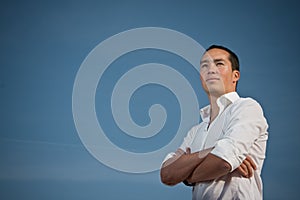 Youth standing with arms folded