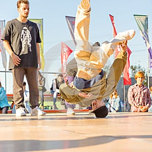 Youth street dances. A young man performs dance moves