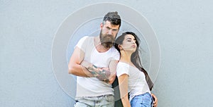 Youth stylish outfit. Couple friends hang out together grey wall background. Feel their style. Couple white shirts