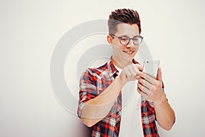 Youth and technology. Studio portrait of man using smart phone. Isolated