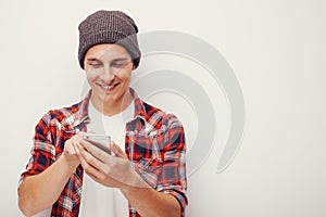 Youth and technology. Studio portrait of man using smart phone. Isolated