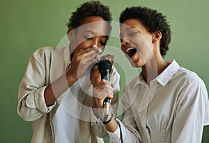 Youthful African American boy and girl performing song during repetition