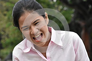 Youthful Asian Teen Girl And Laughter Wearing Pink Shirt Closeup