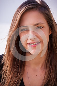 Youthful beautiful teenager with long brown hair