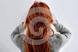 Youthful beauty Red haired womans back view, white background, copy