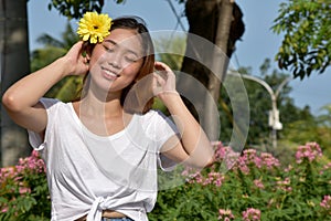 Youthful Diverse Female Smiling With A Daisy