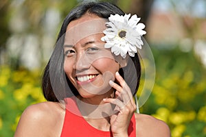 Youthful Female Smiling With A Flower