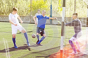 Youthful football players challenging for ball