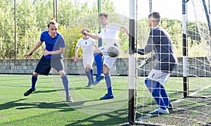Youthful football players challenging for ball