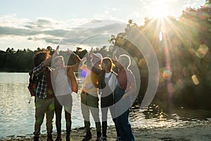 Youthful Friends Celebrating by the Lake at Sunset