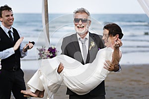 Youthful mature couple getting married at the beach