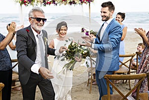 Youthful mature couple getting married at the beach