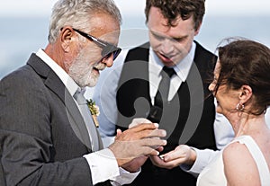 Youthful mature couple getting married at the beach