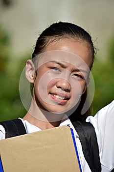 Youthful Minority Female Student Smiling With Notebooks