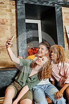 youthful woman taking photo with joyful