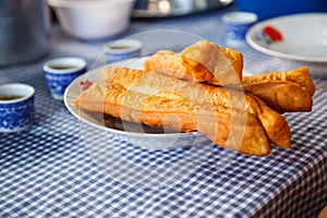 Youtiao Chinese fried churro, Chinese cruller, Chinese oil stick, Chinese doughnut, fried breadstick, long golden brown deep